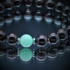 Détail du Bracelet en pierres naturelles avec Amazonite et Grenat, monté sur fil élastique avec perle en acier inoxydable.